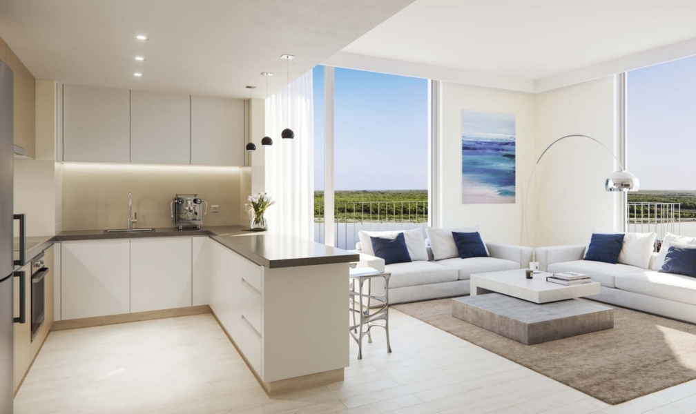 Spacious living room with access to balcony overlooking canal and garden views.