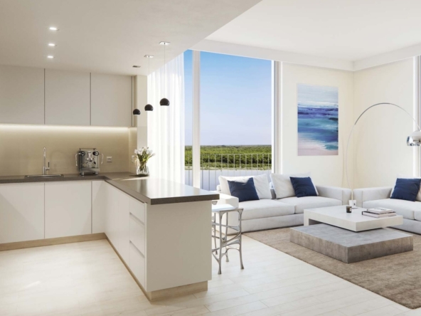 Spacious living room with access to balcony overlooking canal and garden views.